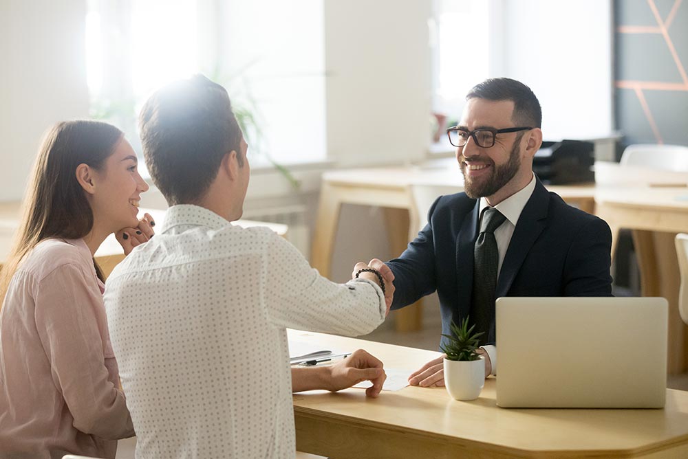 Real Estate Agent with Couple — Property Valuation in Caloundra, QLD Real Estate Agent with Couple — Property Valuation in Caloundra, QLD