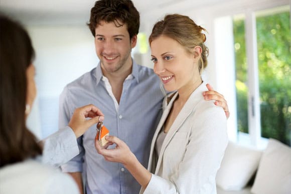 Happy Young Couple Getting Keys Of Their New House