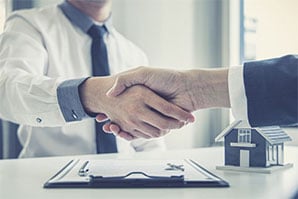 Real Estate Agent And Client Shake Hands